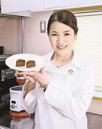 アレルギー対応のチョコレートケーキを手にする上田まり子さん＝松江市津田町